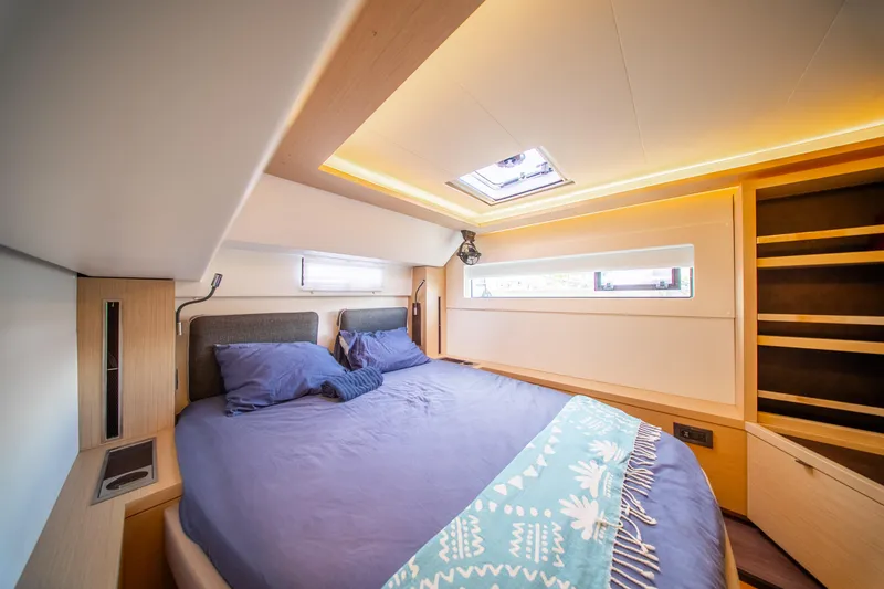 Slide: The Image of Luxurious bedroom interior of 2023 Lagoon 46 yacht with modern design and ambient lighting. - 83
