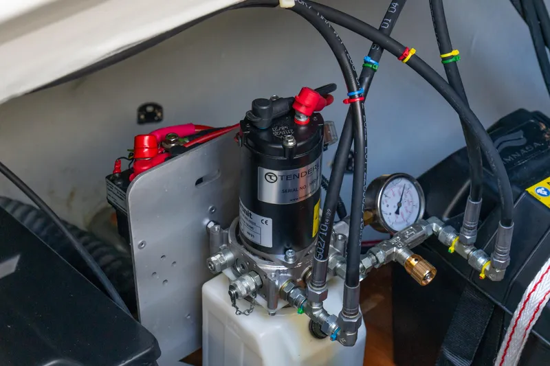 Slide: The Image of Engine compartment of 2023 Lagoon 46 yacht, featuring hydraulic system and battery connections. - 89