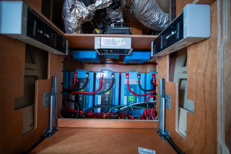 Slide: The Image of Electrical system inside 2023 Lagoon 46 yacht, featuring batteries and wiring setup. - 90