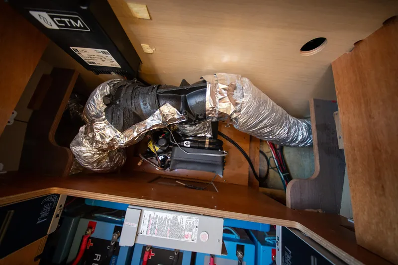 Slide: The Image of Interior view of 2023 Lagoon 46 yacht showing electrical and ductwork components. - 95