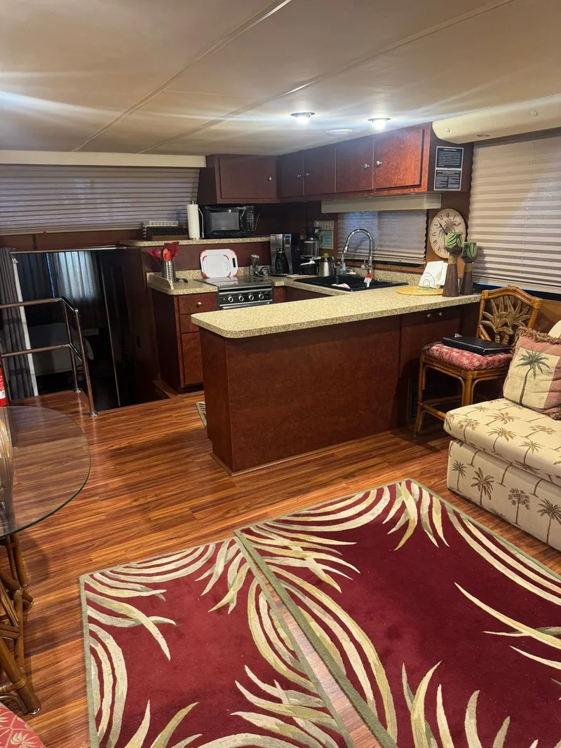 Slide: The Image of Interior of a 2006 Gibson 5500 yacht featuring kitchen and living area. - 11