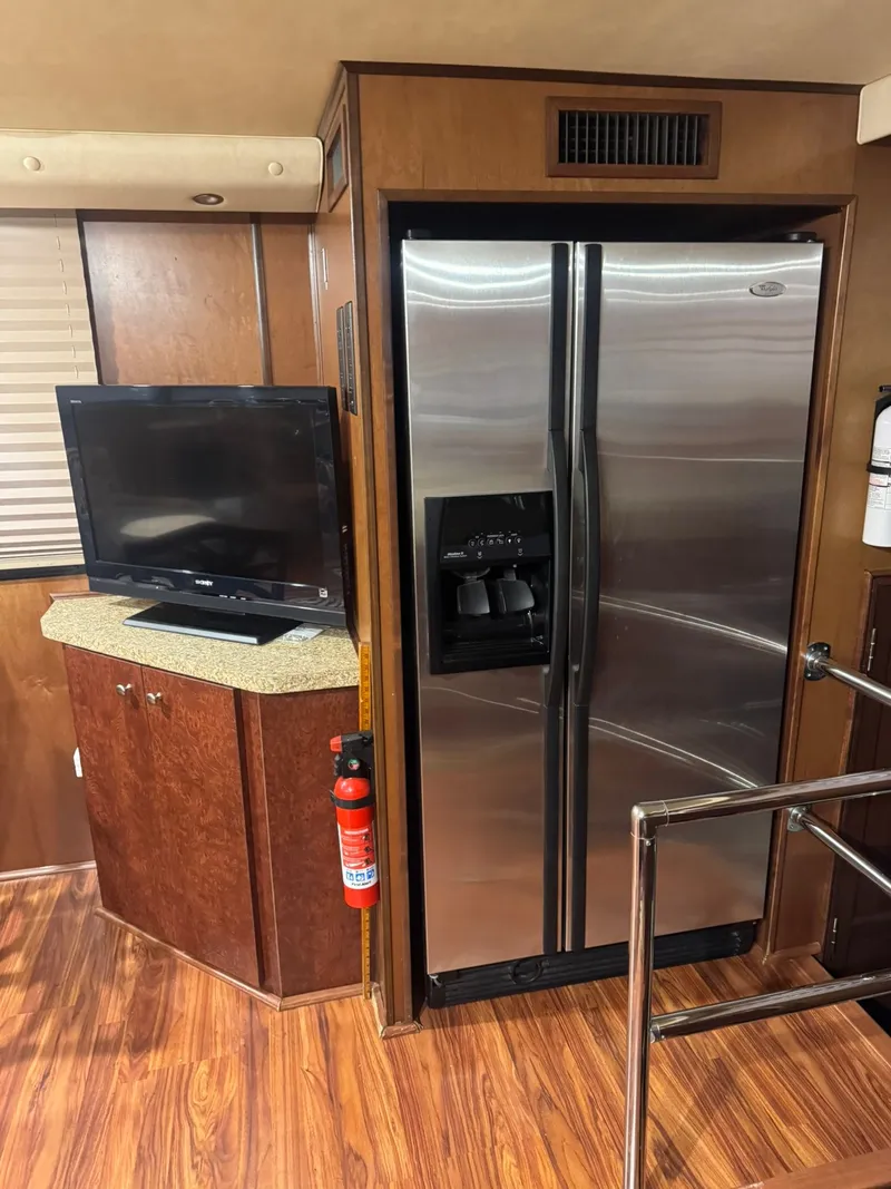 Slide: The Image of Interior of a 2006 Gibson 5500 with refrigerator and TV. - 14