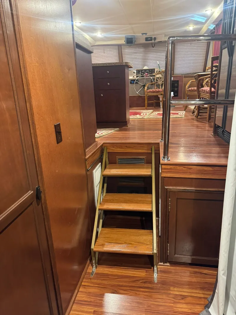 Slide: The Image of Interior of a 2006 Gibson 5500 yacht with wooden stairs and cabinets. - 15