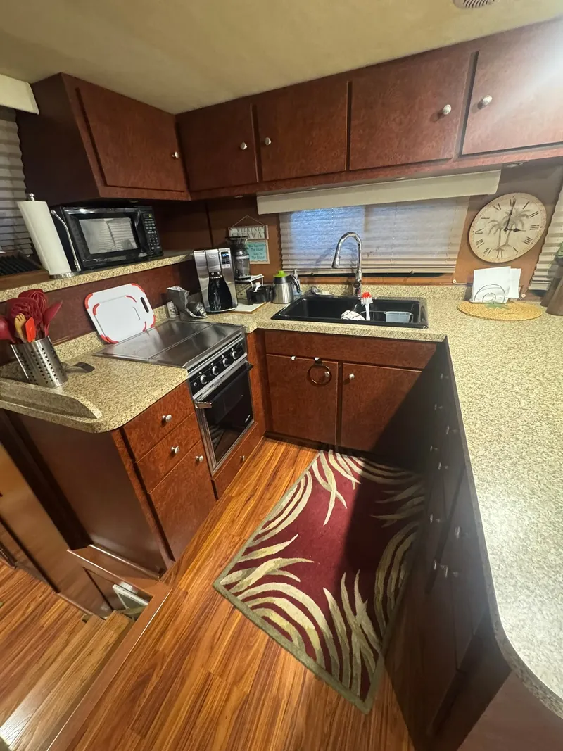 Slide: The Image of Compact kitchen in a 2006 Gibson 5500 with wooden cabinets. - 26