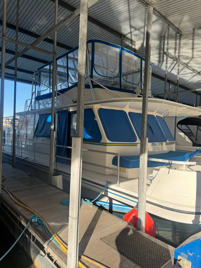 Slide: The Image of 2006 Gibson 5500 boat docked with blue covers. - 28