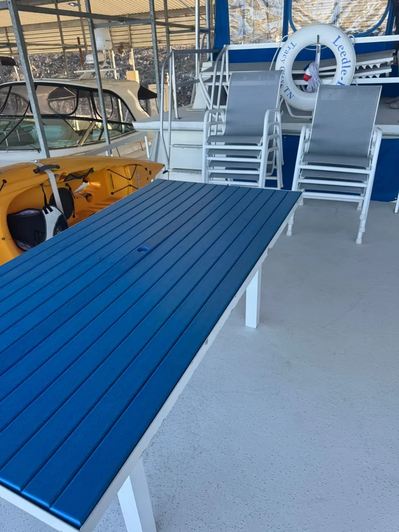 Slide: The Image of Gibson 5500 boat with blue table and chairs, year 2006. - 8