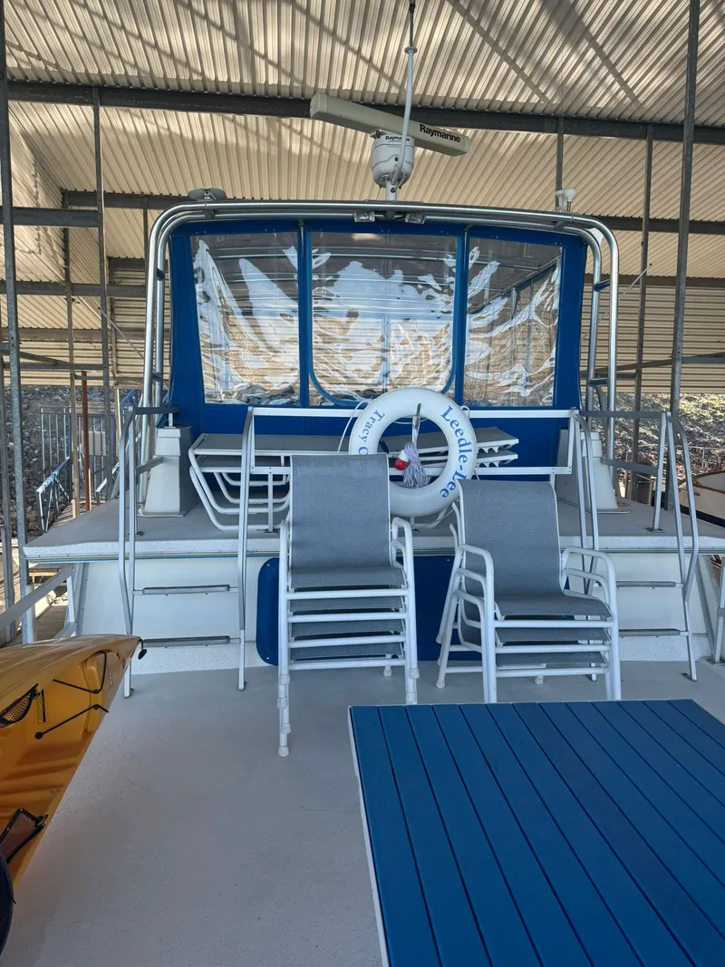 Slide: The Image of 2006 Gibson 5500 boat with blue accents and chairs. - 9