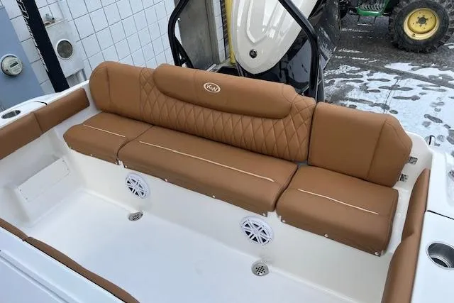 Slide: The Image of 2026 Key West 239 FSR boat with tan cushioned seating and integrated speakers. - 10