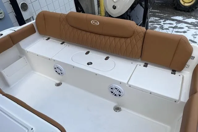 Slide: The Image of 2026 Key West 239 FSR boat interior with tan seating and white deck. - 11