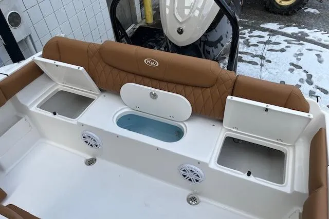 Slide: The Image of 2026 Key West 239 FSR boat interior with tan seating and storage compartments. - 12