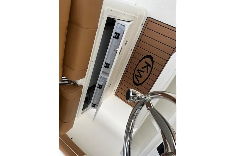 Slide: The Image of 2026 Key West 239 FSR boat interior with storage compartment and KW logo. - 15