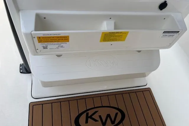 Slide: The Image of 2026 Key West 239 FSR boat interior with KW logo mat and storage compartment. - 17