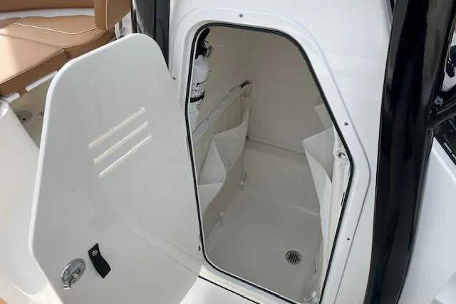 Slide: The Image of 2026 Key West 239 FSR boat interior storage compartment with open door. - 22
