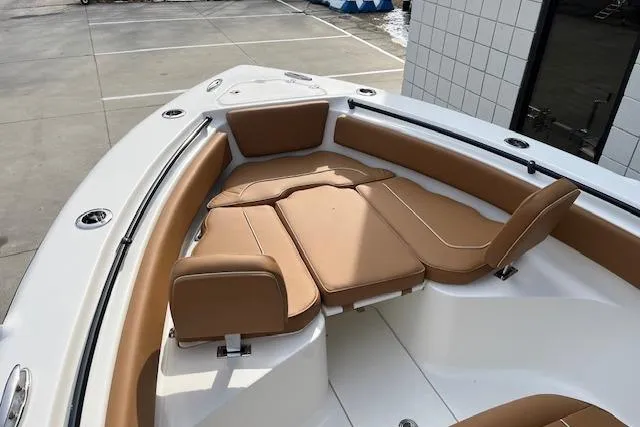 Slide: The Image of 2026 Key West 239 FSR boat with tan cushioned seating in the bow area. - 23