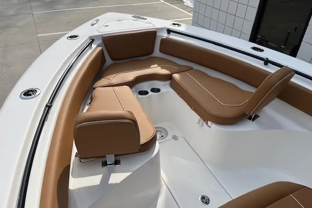 Slide: The Image of 2026 Key West 239 FSR boat interior with tan seating and white deck. - 24