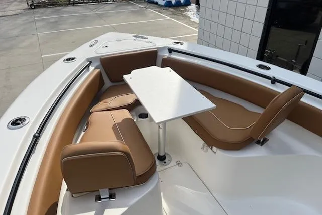 Slide: The Image of 2026 Key West 239 FSR boat interior with tan seating and a central table. - 25