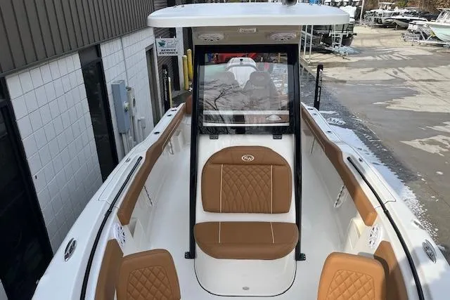 Slide: The Image of 2026 Key West 239 FSR boat with tan seating, docked outdoors. - 27