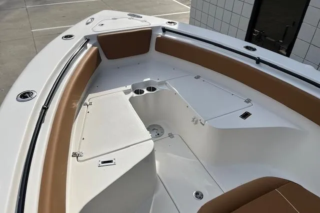 Slide: The Image of 2026 Key West 239 FSR boat interior with tan seating and storage compartments. - 28