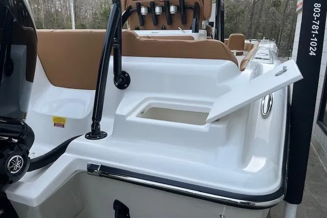 Slide: The Image of 2026 Key West 239 FSR boat with open storage compartment and Yamaha engine. - 5