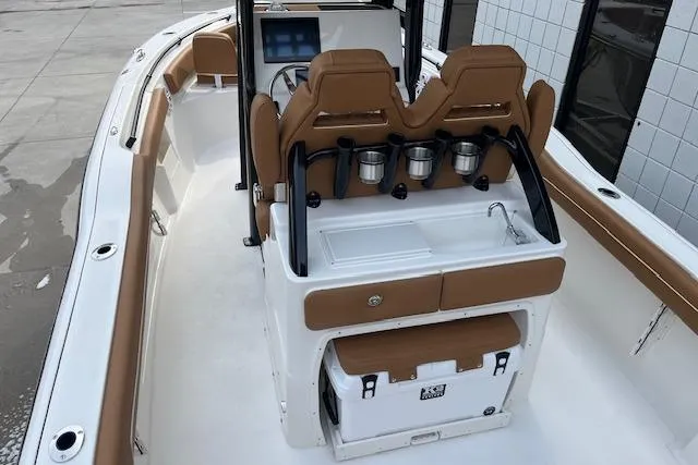 Slide: The Image of 2026 Key West 239 FSR boat interior with tan seating and modern console. - 7