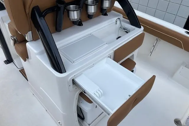 Slide: The Image of 2026 Key West 239 FSR boat interior with storage compartments and cup holders. - 8