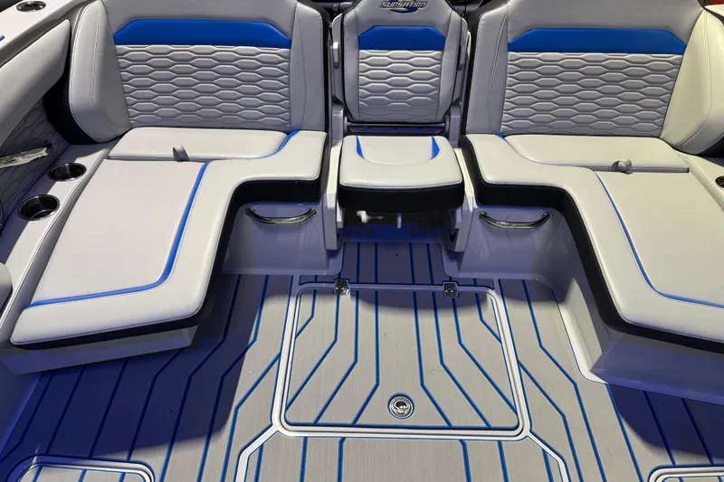 Slide: The Image of 2025 Sunsation 32 CCX boat interior with blue-accented seating and modern design. - 10