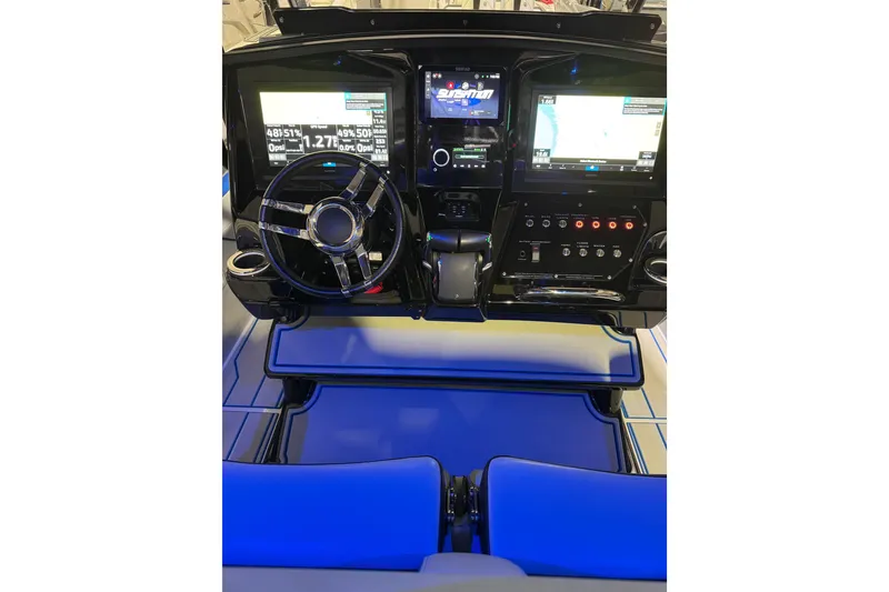 Slide: The Image of 2025 Sunsation 32 CCX boat dashboard with illuminated controls and dual display screens. - 12