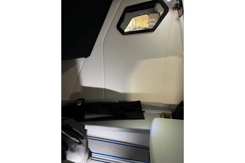 Slide: The Image of Interior cabin of 2025 Sunsation 32 CCX boat, featuring sleek design and window. - 16