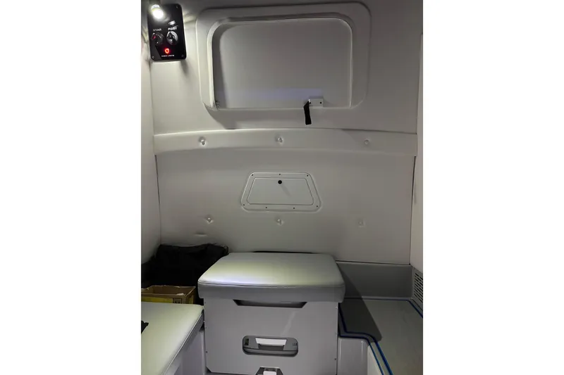 Slide: The Image of Interior of 2025 Sunsation 32 CCX boat cabin with seating and control panel. - 17