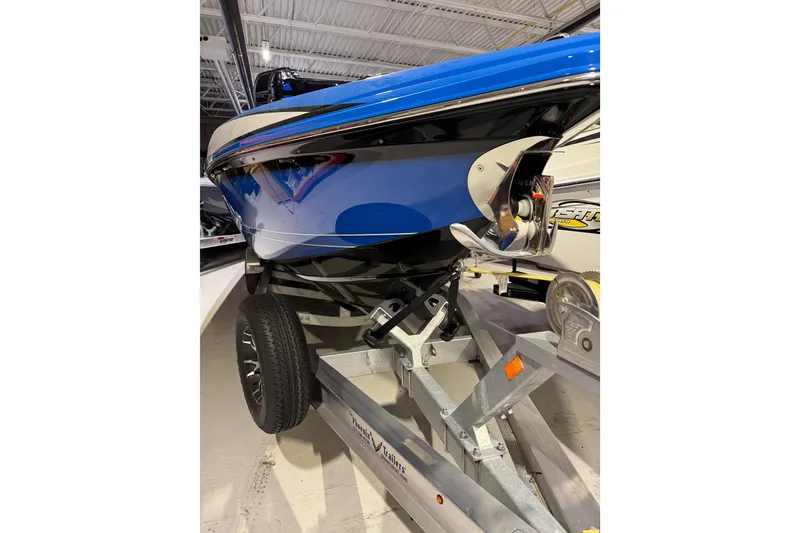 Slide: The Image of 2025 Sunsation 32 CCX boat on trailer, showcasing sleek blue hull design. - 5