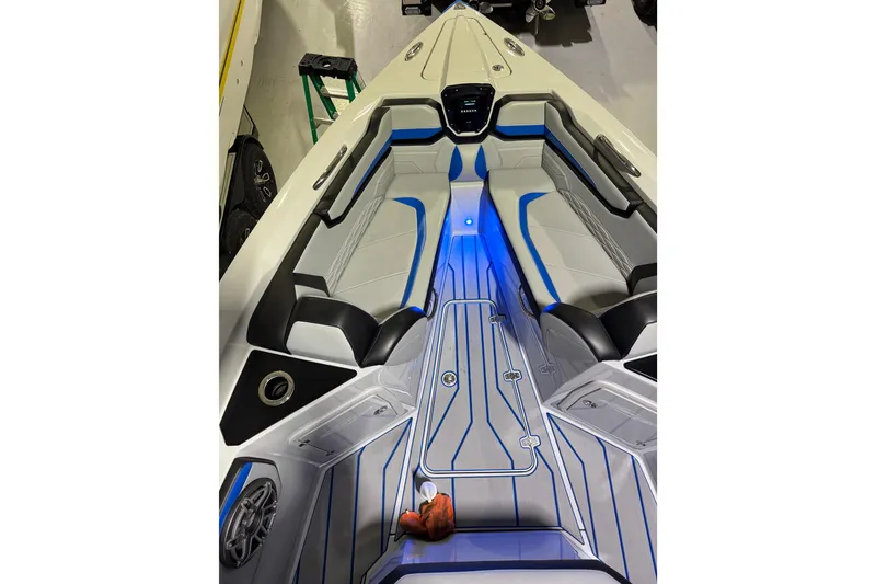 Slide: The Image of 2025 Sunsation 32 CCX boat interior with blue LED lighting and sleek seating design. - 6