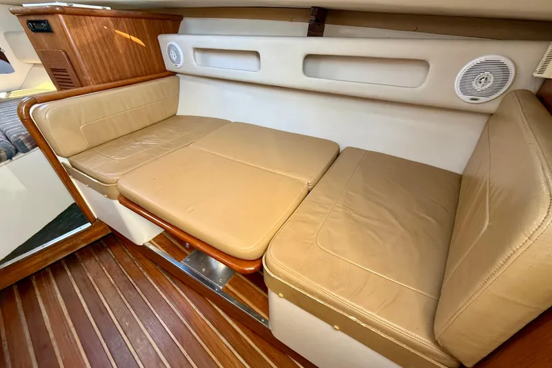 Slide: The Image of 2000 Pursuit 3000 Express cabin interior with beige leather seating and wood flooring. - 10