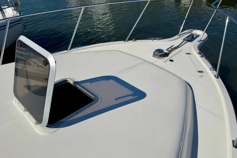 Slide: The Image of 2000 Pursuit 3000 Express boat deck with open hatch and anchor chain. - 13