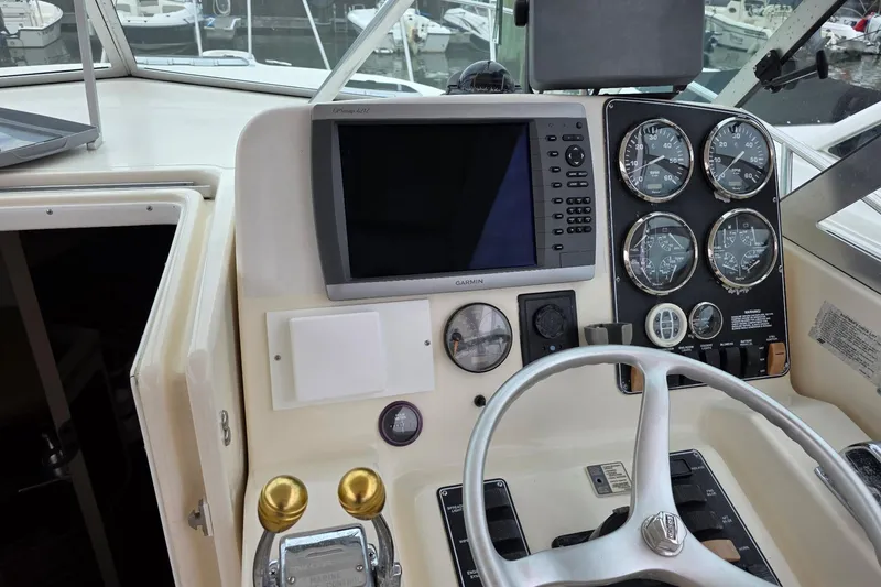 Slide: The Image of Helm of 2000 Pursuit 3000 Express boat with Garmin navigation and gauges. - 4