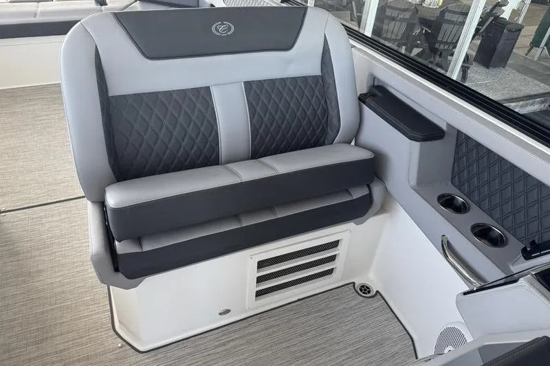 Slide: The Image of 2024 Cobalt R35 boat interior with gray quilted seating and cup holders. - 19