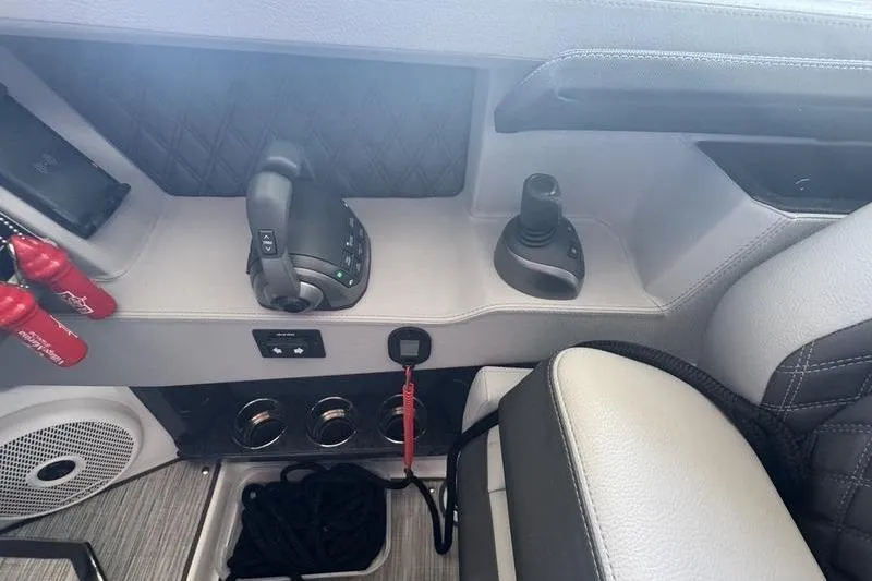 Slide: The Image of 2024 Cobalt R35 boat interior with control panel and joystick. - 25