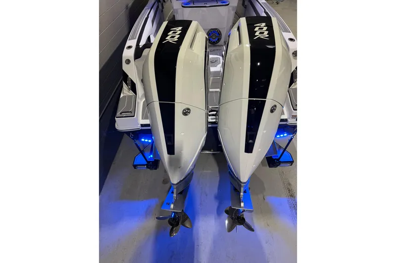 Slide: The Image of 2026 Sunsation 32 CCX boat with dual 400R engines, illuminated in blue lighting. - 7