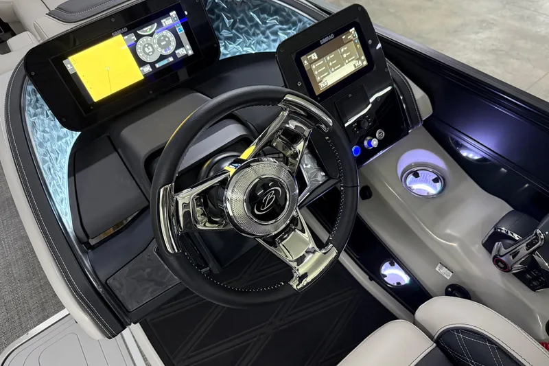 Slide: The Image of 2026 Barletta Lusso 25UA boat dashboard with modern steering and digital displays. - 26