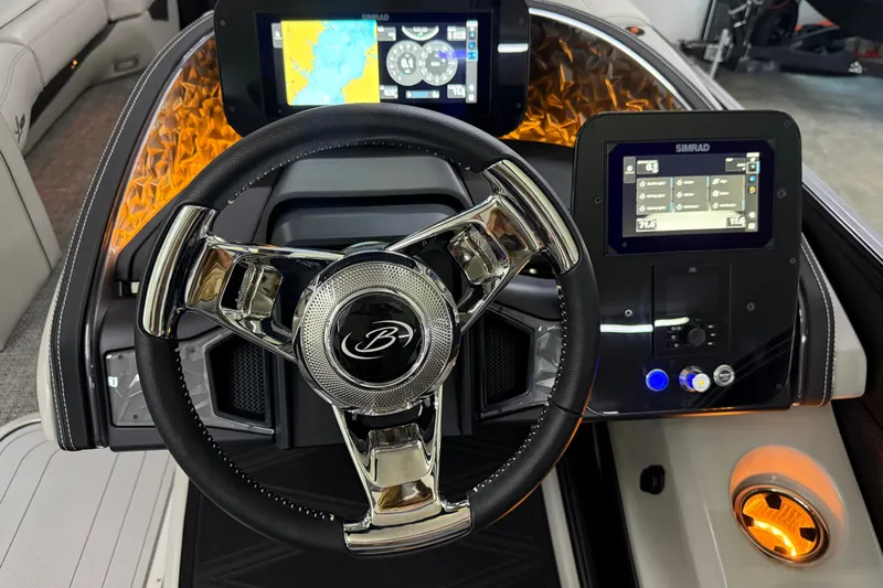 Slide: The Image of 2026 Barletta Lusso 25UA boat dashboard with modern steering wheel and digital displays. - 29