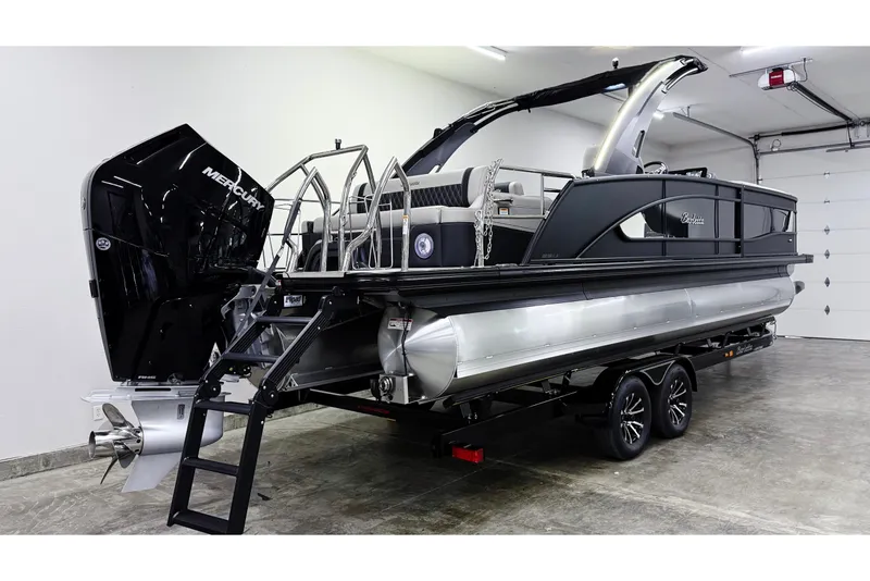 Slide: The Image of 2026 Barletta Lusso 25UA pontoon boat with Mercury engine in a garage setting. - 3