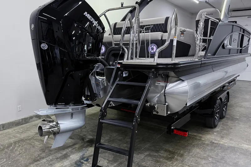 Slide: The Image of 2026 Barletta Lusso 25UA pontoon boat with Mercury engine in a showroom. - 5
