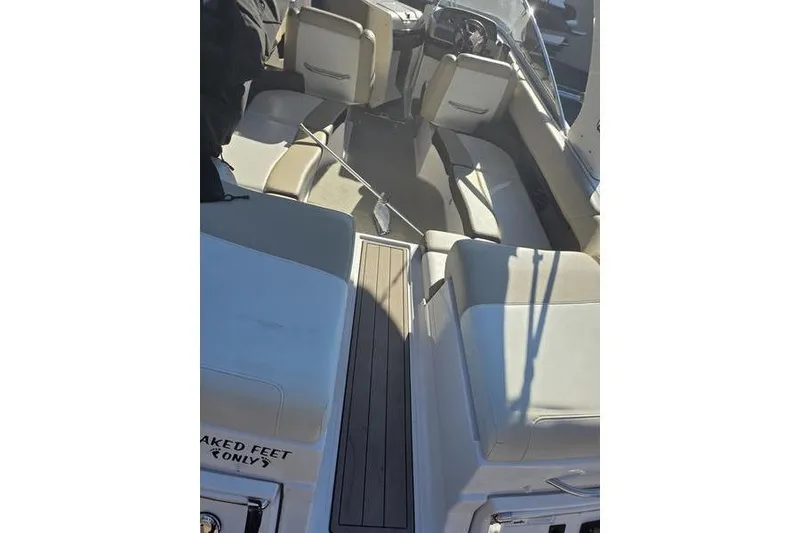 Slide: The Image of 2013 Regal 2700 ES Bowrider interior with beige seating and wooden flooring. - 13