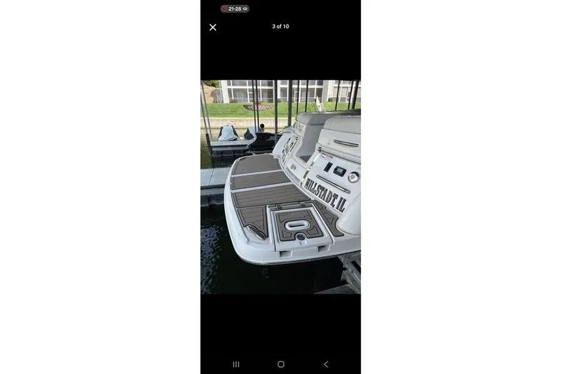 Slide: The Image of 2013 Regal 2700 ES Bowrider boat on trailer, rear view, sunny day. - 2