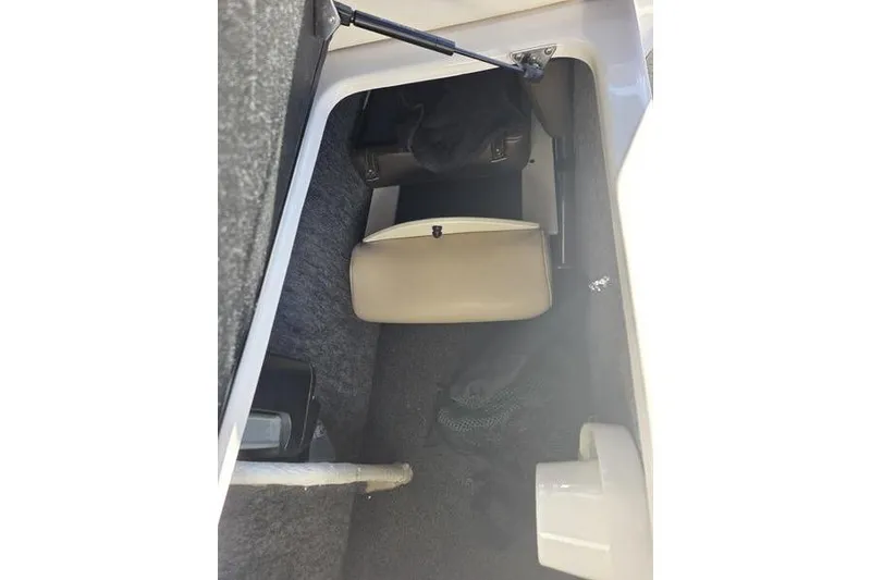 Slide: The Image of Interior storage compartment of 2013 Regal 2700 ES Bowrider boat, featuring carpeted flooring. - 6