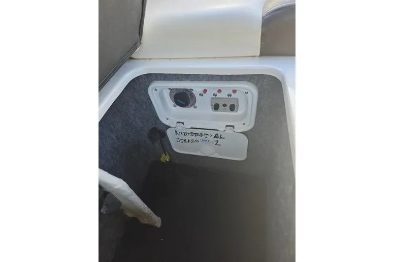 Slide: The Image of Control panel inside 2013 Regal 2700 ES Bowrider boat, featuring labeled switches and dials. - 7