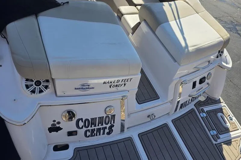 Slide: The Image of 2013 Regal 2700 ES Bowrider boat with cushioned seating and "Common Cents" text. - 9