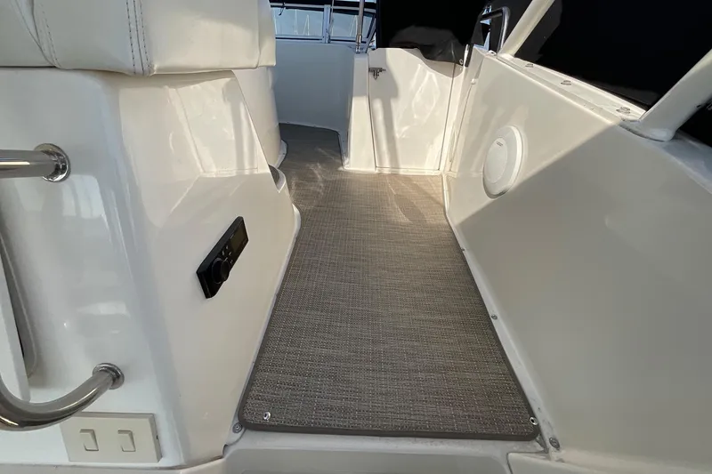 Slide: The Image of 2000 Silverton 392 Motor Yacht interior walkway with carpet and seating. - 10