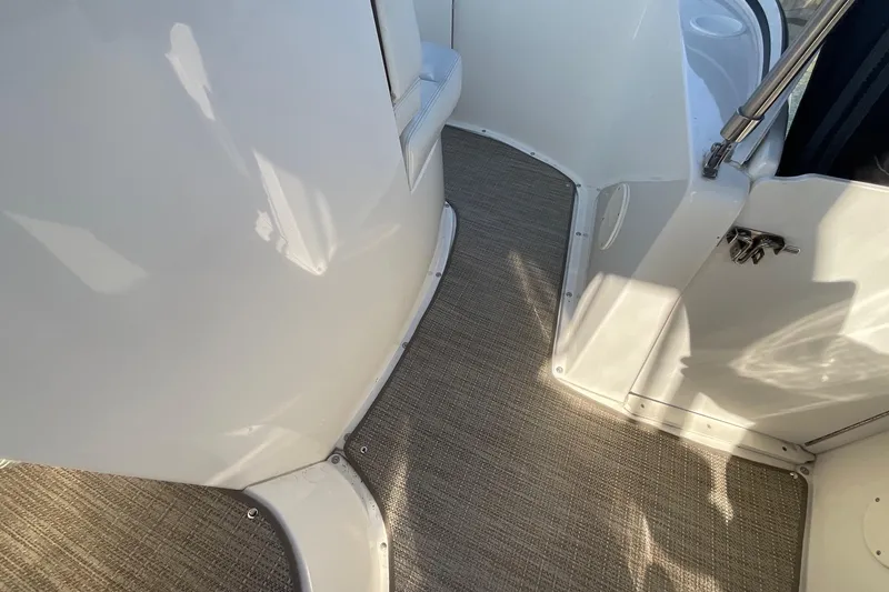 Slide: The Image of Interior view of 2000 Silverton 392 Motor Yacht with carpeted flooring and sleek white surfaces. - 12