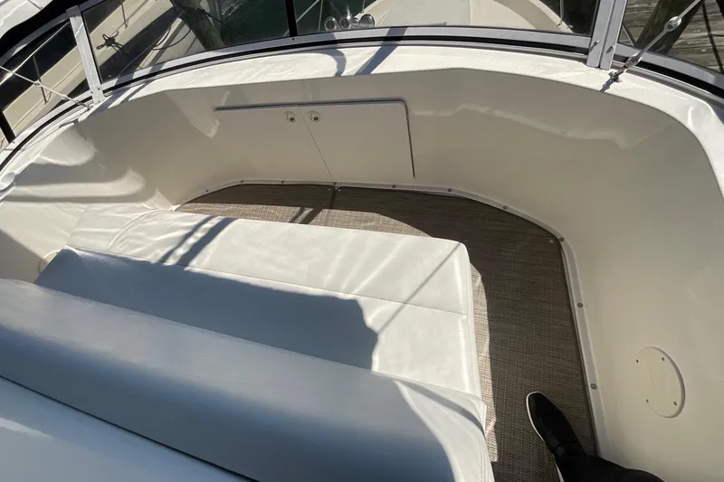 Slide: The Image of Interior seating area of a 2000 Silverton 392 Motor Yacht, featuring white upholstery. - 17