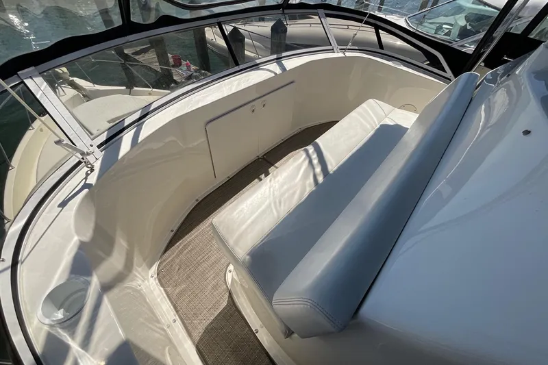 Slide: The Image of 2000 Silverton 392 Motor Yacht interior with cushioned seating and panoramic windows. - 20